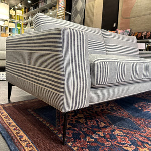 side view of grey and white striped sofa