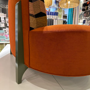 back view of curved orange sofa
