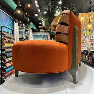 side view of custom made curved orange velvet sofa
