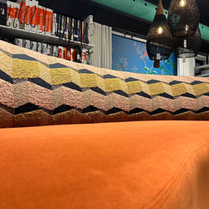 close up of orange velvet sofa fabric
