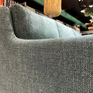 side view of custom green tweed sofa fabric