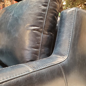 close up of custom swivel chair done in top grain blue leather