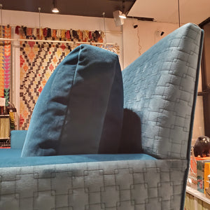 close up of custom sofa in brilliant Peacock Teal velvet and quilted geometric pattern 