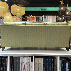 back view of green upholstered sofa