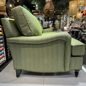 side view of green upholstered sofa