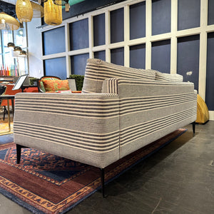 back view of grey and white striped sofa