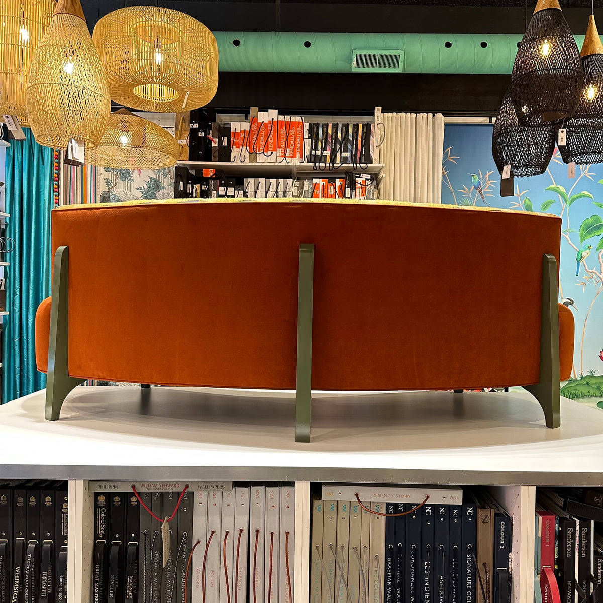 back view of curved orange velvet sofa