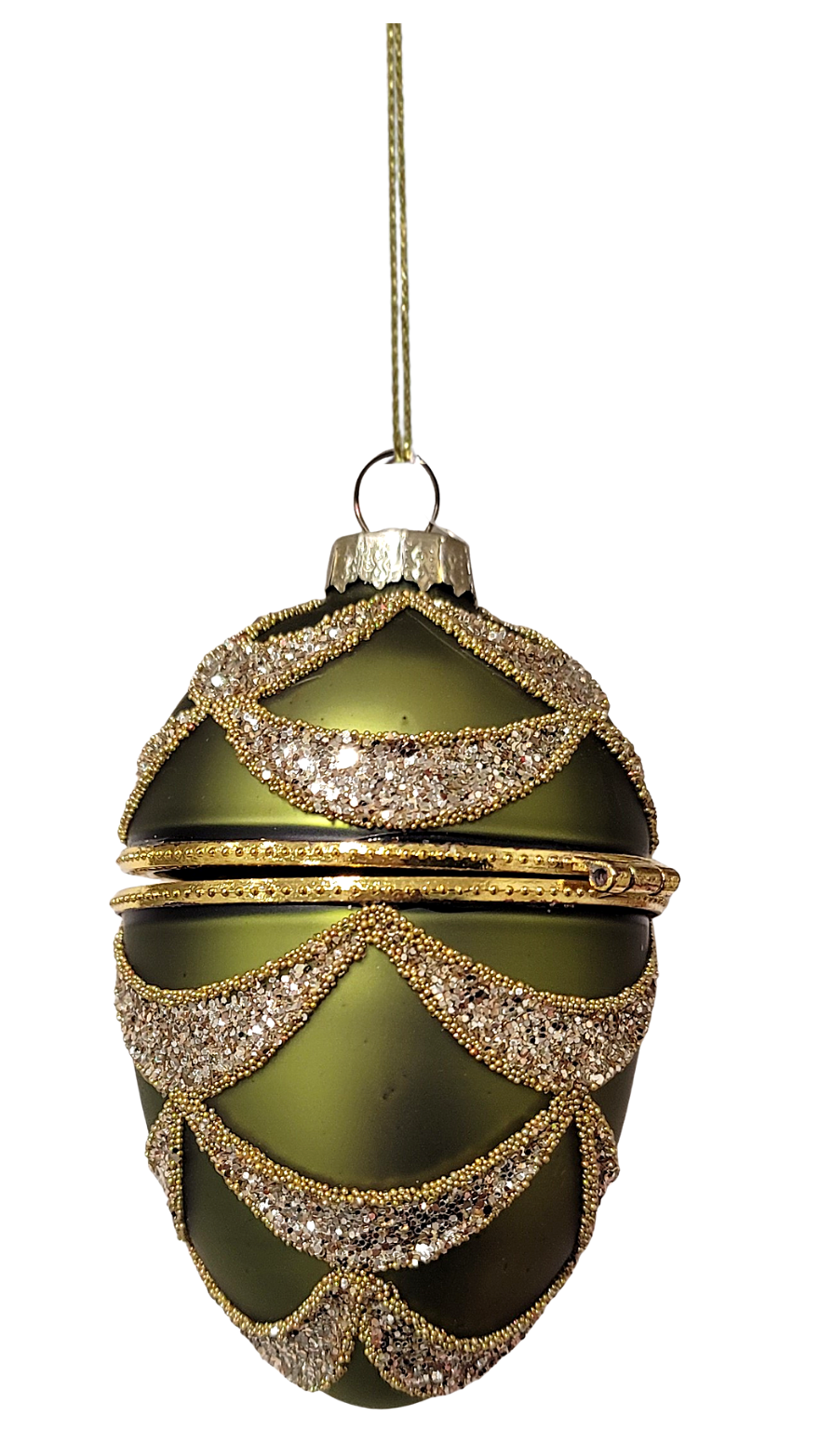 Glass hinged keepsake ornament in dark green and gold.