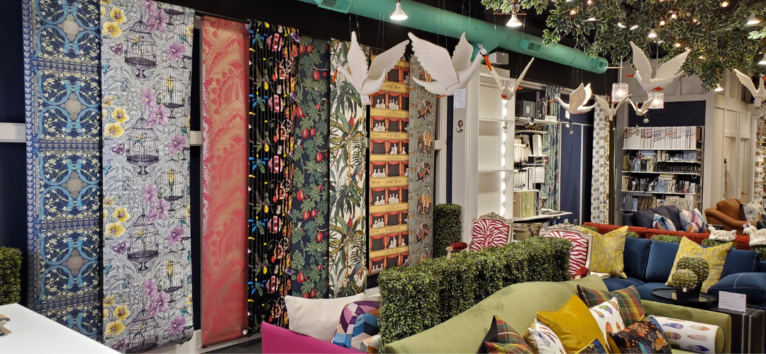 A studio shot of Kendall & Co. Interior Design Shop, showing wallpaper and sofas. 