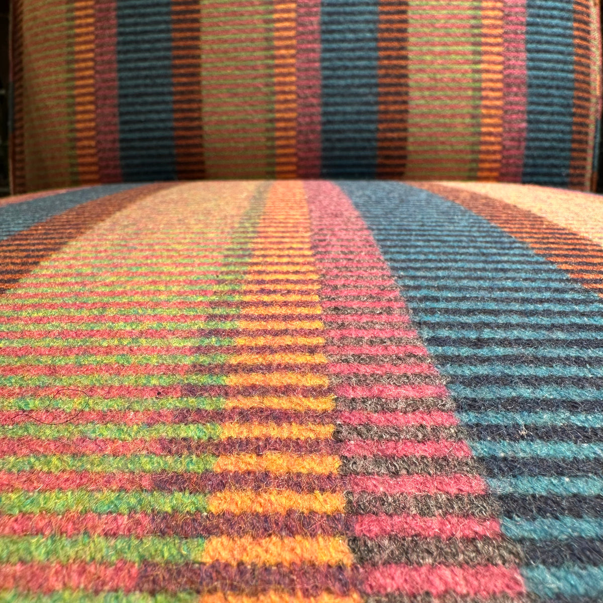 The Cambridge recliner in striped wool with corduroy piping in burnt orange.