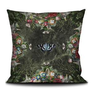 Decorative velvet throw pillow with moth and flowers.