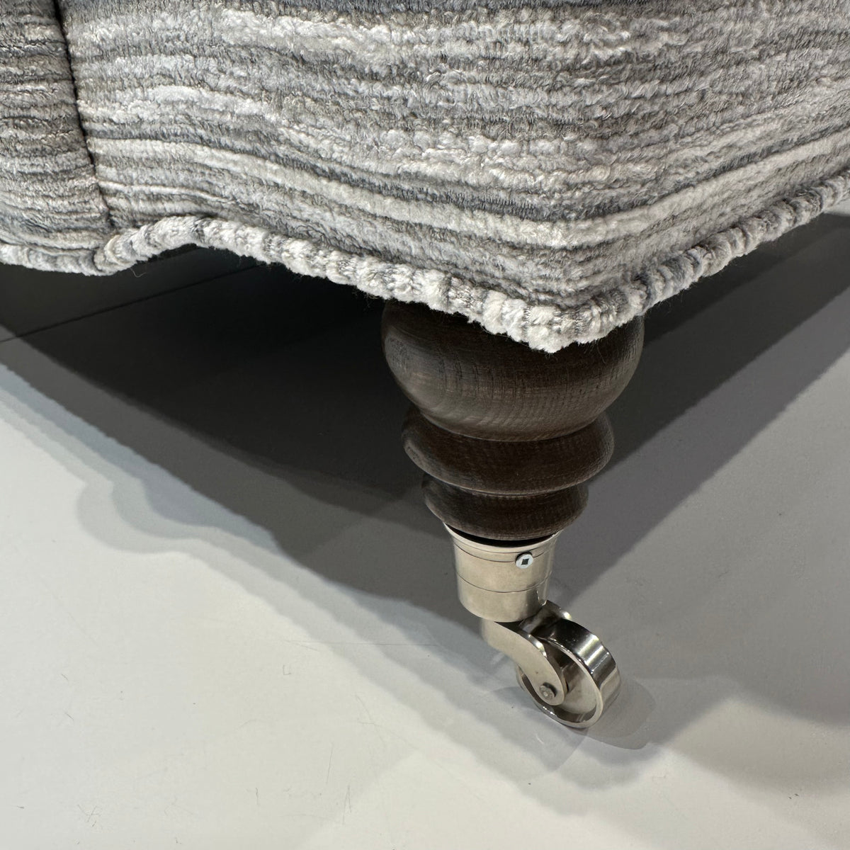 Close-up of Ingonish armchair silver leg caster.