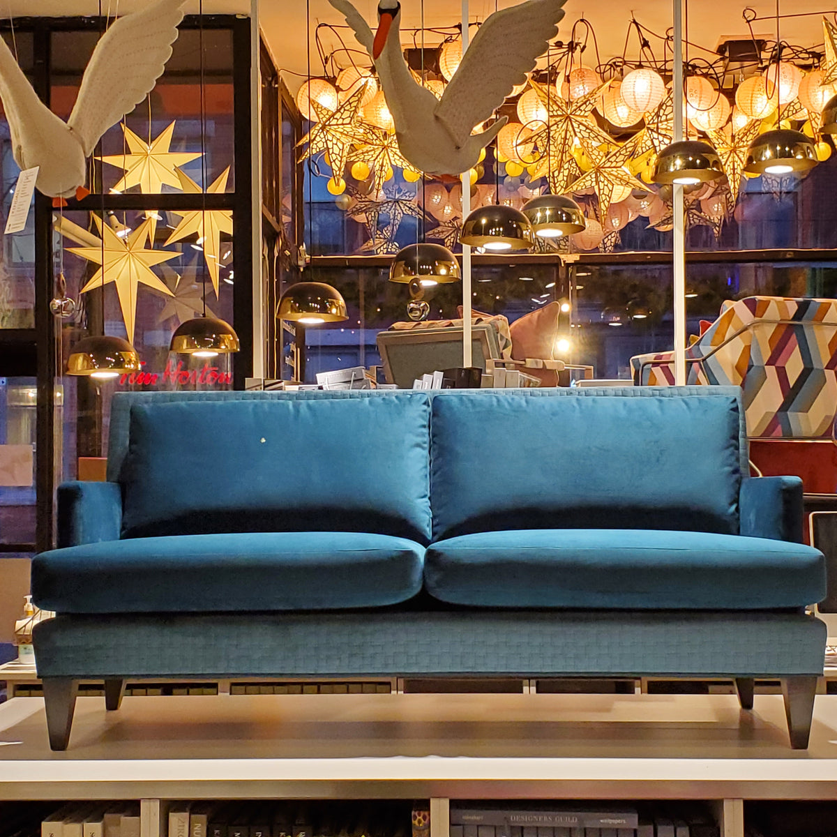 custom sofa in brilliant Peacock Teal velvet and quilted geometric pattern 