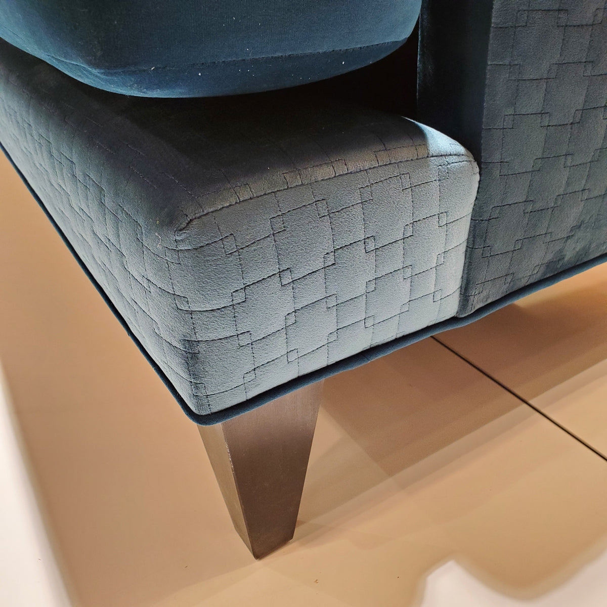 close up of custom sofa in brilliant Peacock Teal velvet and quilted geometric pattern 