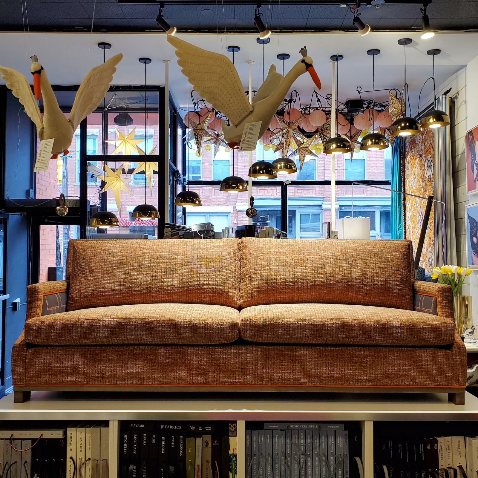custom sofa in stain-resistant nubbly textured fabric, contrast embroidered fabric on the arms and orange velvet piping