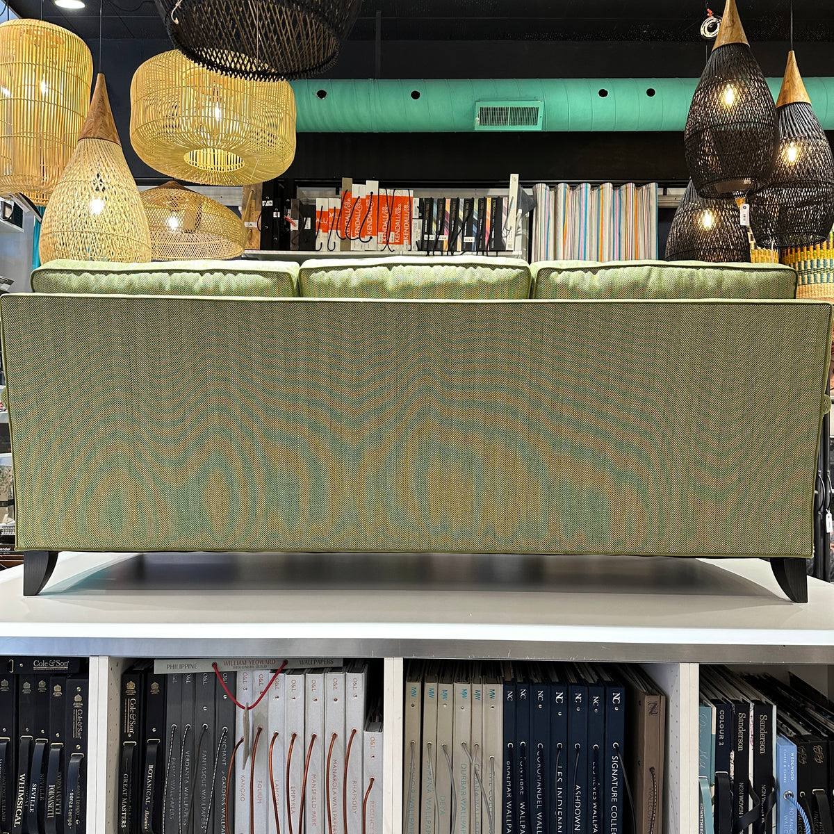 back view of green upholstered sofa